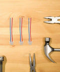 Four Piece Motorcycle Wiring Harness Kit with Copper and Plastic Build for Electric Bikes and Motorcycles on wooden table.
