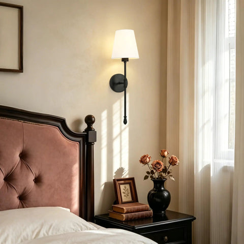 KSANA Modern Black Wall Scone Lighting Indoor with White Fabric Shade next to a bed with decorative elements.