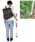 Person holding Manual Fertilizer Spreader With Bag For Farm Crops And Garden Use Accurate Measurement Fertilizing Tool near corn plant