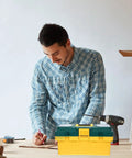 Heavy Duty Portable Plastic Toolbox With Secure Locking Latch And Multi Compartment Storage on a work table during a project.