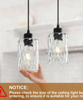 Two Pack Black Hammered Glass Pendant Lights With Adjustable Cords For Kitchen Island modern hanging lamp fixtures showcased with hand.