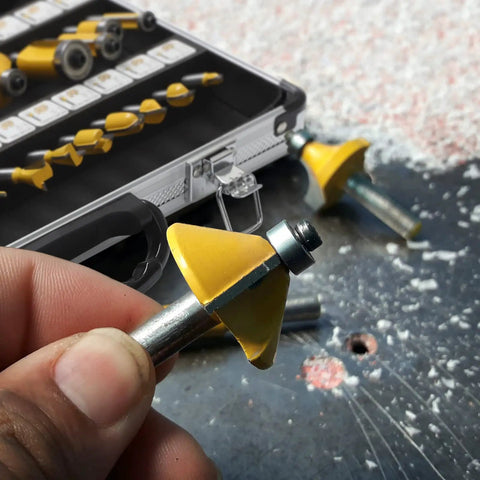 Person holding a yellow carbide tipped bit from Router Bit Set Half Inch Shank, 35 Piece Kit For Woodworking, Pro And DIY Friendly.