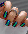 CurvLife Short Square Chrome Press On Nails With Electric Mirage Colorful Finish on fingers with glossy shine and colorful reflection.