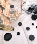 80 Pieces Silicone Hole Plugs Kit With 7 Sizes From One Quarter Inch To One Inch Round Plugs for various uses displayed on fabric