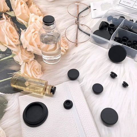 80 Pieces Silicone Hole Plugs Kit With 7 Sizes From One Quarter Inch To One Inch Round Plugs for various uses displayed on fabric