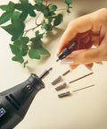 Hand holding quick change rotary tool collet nut set five piece kit with 480 481 482 483 collets and nut near Dremel tool