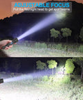 Person using Beast Mode 2000 Lumen Rechargeable LED Flashlight Tactical Torch With Clip, IPX6 water-resistant, adjustable focus beam in woods.