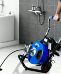 Heavy Hitter Electric Drain Cleaner Machine With 100 Foot Snake Cable in bathroom, ready to clear clogs from floor drain.