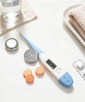 Premium Leak Proof LR41 Button Batteries AG3 Alkaline Cells 10 Pack with thermometer and vitamin tablets on a table.