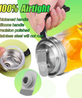 Close-up of stainless steel pour spout lid with handle on jar, airtight seal, holding orange beverage, for kitchen storage and drinks.