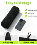 Black Waterproof Sweat Towel Seat Cover rolled with phone, storage bag, and elastic strap, ideal for workouts and outdoor activities.