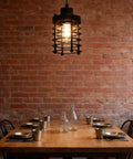 Vintage Iron Cage Pendant Light, Industrial Hanging Lamp Rustic, 47" over wooden dining table with metal dishes in a cozy setting.