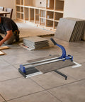 Heavy Duty 24 Inch Manual Tile Cutter For Ceramic And Porcelain Floors Includes Tungsten Blade Ruler And Balancing Rack in use on tile floor.