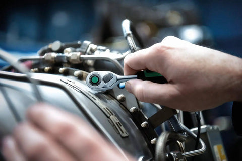 Hand using One Quarter Inch Drive Quick Release Ratchet with Eighty Teeth Reversible Design Safety Lock and Two Component Handle in machinery