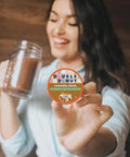 Woman holding a Caramel Swirl Decaf Coffee Pod For Keurig K Cup, highlighting flavored decaf medium roast coffee.