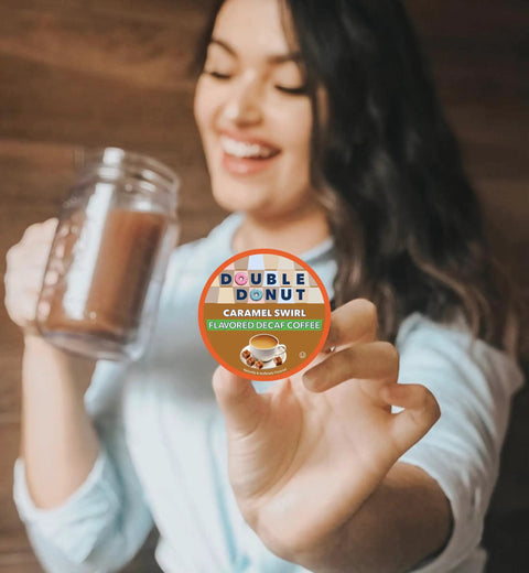 Woman holding a Caramel Swirl Decaf Coffee Pod For Keurig K Cup, highlighting flavored decaf medium roast coffee.