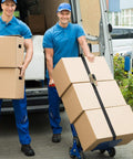 Workers securing boxes with Endless Ratchet Straps No Hook Nylon Tie Downs for Motorcycles and Kayaks on dolly, demonstrating use.