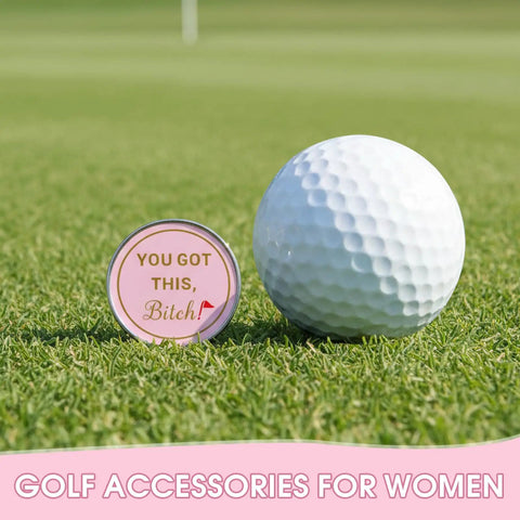 Cute Pink Golf Ball Marker Hat Clip For Women Gals Golf Accessory on grass next to a golf ball.