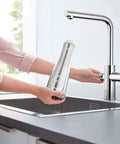 Clean Lines Single Handle Pull Out Kitchen Faucet With Laminar Spray Led Knobs For Chilled Sparkling Water Butter Smooth Pour 180 Swivel Spout in use, filling stainless bottle.