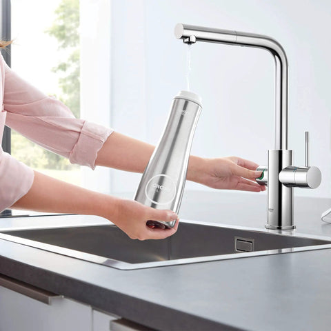 Clean Lines Single Handle Pull Out Kitchen Faucet With Laminar Spray Led Knobs For Chilled Sparkling Water Butter Smooth Pour 180 Swivel Spout in use, filling stainless bottle.