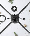 Base of heavy duty outdoor extension cord, black removable stand part, surrounded by snowflakes and ornaments, 12 gauge cord visible
