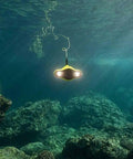 Five Thruster Mini Underwater Drone With 4K Ultra HD Camera And 100m Tether exploring ocean with coral reef background.