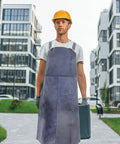 Heavy Duty Cowhide Welding Apron Built To Last For Tough Jobs With Serious Heat Protection And Soldering Defense worn by a worker.