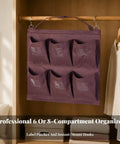 Slick Heavy Duty Six Pocket Hanging Closet Organizer With Reinforced Carry Handle And Breathable Storage Slots For Streamlined Wardrobe Sorting And Daily No Stress Organization In Matte Black displayed in a closet.