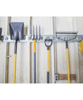Heavy Duty Dual Arm Tool Hook For E Track And X Track Stores Long Handled Tools Like Brooms And Rakes 200 Lb Capacity Zinc Steel 2.25 Inch Inside Hook Works With Tool Stabilizer For Extra Securement installed on wall with tools