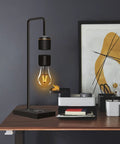 Unique Modern Levitating Lamp With Floating Light And Built In Qi Wireless Charger on office desk setup