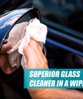 Using Streak Free Glass Cleaning Wipes Canister for Home and Auto Lint Free Ammonia Free Tint Safe Wipes on a car mirror