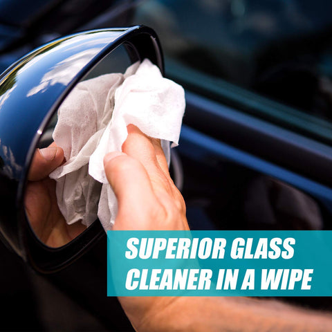 Using Streak Free Glass Cleaning Wipes Canister for Home and Auto Lint Free Ammonia Free Tint Safe Wipes on a car mirror