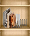 Super Sturdy Stainless Steel Pot Lid Organizer And Cutting Board Rack with various lids and cutting boards in a cabinet.
