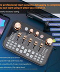 Top view of Pro Gaming Audio Mixer Sound Board with four gold knobs, five sliders, next to a smartphone and microphone.