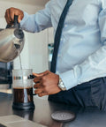 Person using French press with Six Pack French Press Replacement Filters 4 Inch Stainless Steel Mesh for 34 Oz Coffee Makers