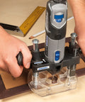 Bench Mounted Router Table Adapter For Corded Rotary Power Tools Featuring Six Hardened Steel Shaping Bits in use with Dremel tool.