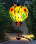 Hot Air Balloon Solar Lantern For Outdoor Use, Dragonfly Inspired Glass Hanging Light For Patio And Garden Decor, glowing in garden