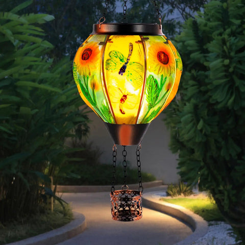 Hot Air Balloon Solar Lantern For Outdoor Use, Dragonfly Inspired Glass Hanging Light For Patio And Garden Decor, glowing in garden