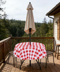 Round 60 Inch Outdoor Tablecloth With Umbrella Hole And Zipper, Red And White Gingham, Spill Proof And Washable, on patio table