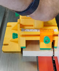 Close-up of GRR Ripper Safe Rip Upgrade Kit For Table Saw Safety on pushblock aligning with wood for precise cutting.