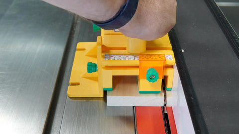 Close-up of GRR Ripper Safe Rip Upgrade Kit For Table Saw Safety on pushblock aligning with wood for precise cutting.