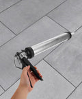 Heavy Duty Metal Caulk Applicator With Thick Steel Rod For Concrete Seams And Tile Grout Lines Smooth Squeeze Sealant Gun in hand