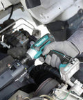 User using 12V Max CXT Impact Wrench 3/8 Inch Drive, Ultra Compact At 6-3/8 Inches, in automotive repair, ergonomic grip visible