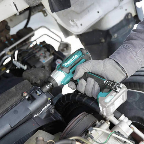 User using 12V Max CXT Impact Wrench 3/8 Inch Drive, Ultra Compact At 6-3/8 Inches, in automotive repair, ergonomic grip visible