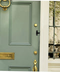 Four Pack Heavy Duty Sliding Door Lock With A Rock Solid 90 Degree Lever And Built Tough Construction installed on green door.