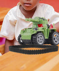 Child playing with toy tank on desk, showcasing Two Pack Rubber Tank Tracks For RC Chassis Long Wide DIY Replacement For Crawlers.