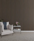 Top Shelf Solid Hardwood Adjustable Slat Wall Kit In Warm Walnut with slats installed in modern living space with chair and side table.