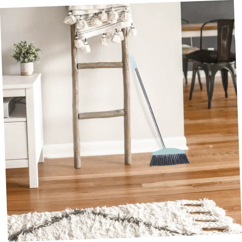 Grime Crushing Heavy Duty Broom With 34 Inch Long Handle For Sweeping Concrete Driveway Garage Patio And Indoor Floors No Sweat Household Cleaner With Convenient Storage Hook leaning against a wooden ladder.