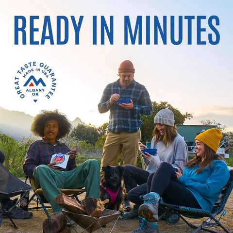 Group enjoying Buffalo Style Chicken Mac And Cheese Freeze Dried Camping Meal With 12 Servings And 30 Year Shelf Life outdoors.