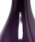 Close-up of curved eggplant purple ceramic base from Curved Eggplant Purple Ceramic Table Lamp With Asymmetrical White Shade Tall 29 Inch Accent Light For Living Room Adds Deep Color And Modern Vibe Uses Three Way Bulb